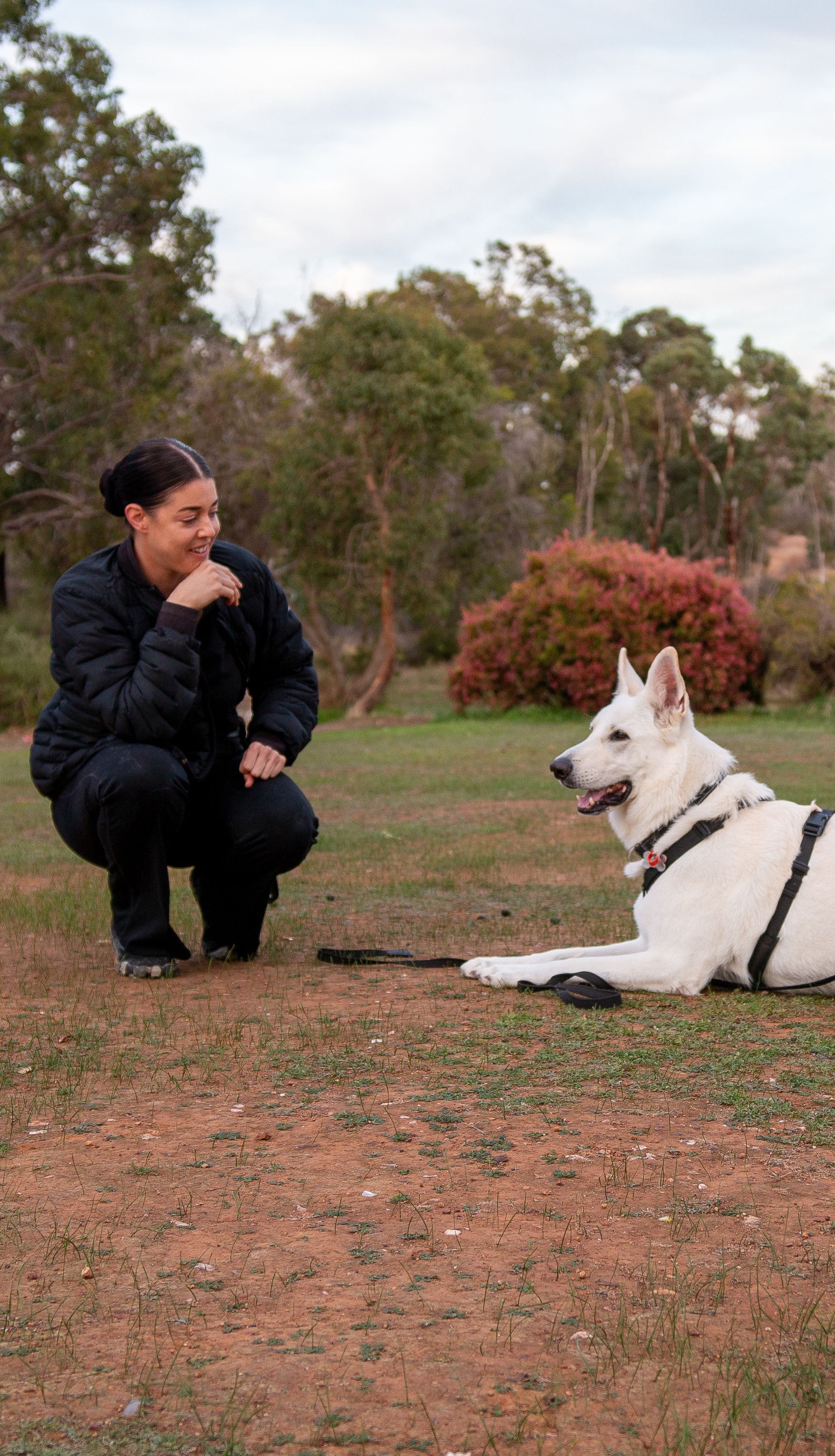 Ashleigh Leece smiling and training a dog